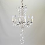 A French gilt metal and glass six branch chandelier, suspended with facet cut drops,