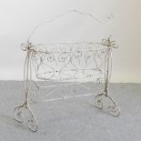 A Victorian white painted metal child's cradle, on stand,