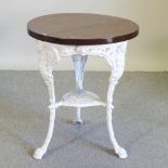 A Victorian cast iron circular pub table, with a later top,