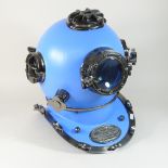 A modern blue painted metal life size model of a diver's helmet,
