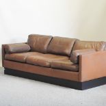 A 1960's Danish style brown leather upholstered sofa,