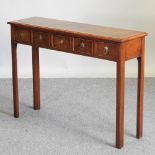 A bespoke made walnut side table, containing five drawers, on square legs,