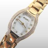 An Ebel 18 carat gold and diamond set small ladies wristwatch, having a signed dial,