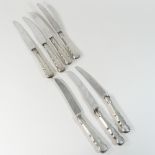 A set of seven 19th century table knives, with silver handles,
