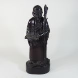 A carved hardwood figure of a Chinese man,