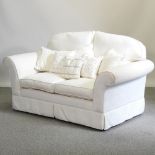 A modern cream damask style upholstered two seater sofa,