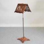 A good quality Victorian walnut duet stand, the adjustable fret carved top,