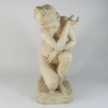 A carved stone figure of crouching Venus, after the antique, on a naturalistic base,