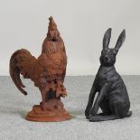 A rusted metal model of a cockerel, together with another of a hare,