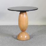 An Art Deco style slate top occasional table, on a shaped oak base,
