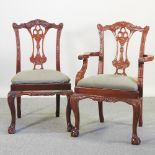 A set of eight 20th century carved Chippendale style dining chairs, with green padded seats,