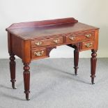 A Victorian mahogany writing table, on reeded legs,