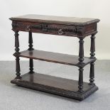 A Victorian carved oak three tier buffet, with a hinged marble inset top,