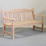 A teak slatted garden bench,