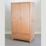 A modern light oak double wardrobe,