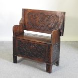 A 19th century carved oak monk's bench,