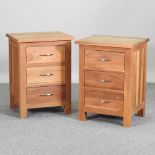 A pair of modern light oak bedside chests,