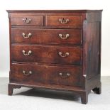 A late George III oak chest of drawers, containing two short over three long drawers,