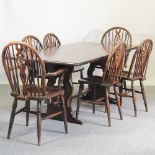 A reproduction oak refectory table, 182 x 90cm, together with a set of six wheel back dining chairs,