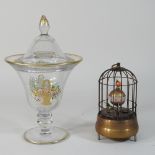 A reproduction bird cage clock, 16cm high, together with a glass jar and cover,