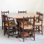 An oak dining table, 165 x 131cm, together with seven Ercol chairs,