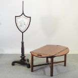 A butler's tray on stand, together with a pole screen,