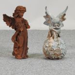 A rusted metal garden figure of a praying angel, together with a seated angel on a ball,