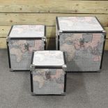 A set of three modern graduated trunks, each decorated with maps,
