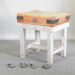 A butcher's block, on square legs,