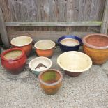 A collection of glazed garden pots,