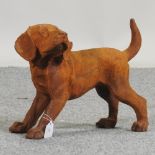 A rusted metal model of a puppy,