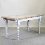 A pine kitchen table with a stripped top, on a grey painted base,
