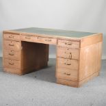 A mid 20th century oak twin pedestal desk,