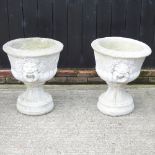 A pair of reconstituted stone planters,