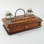 An early 20th century light oak desk stand,