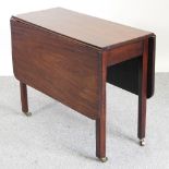A George III mahogany pembroke table, on chamfered square legs, terminating in castors,