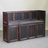 An early 20th century oak pew,