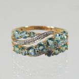 A 9 carat gold green tourmaline and diamond ring, of crossover design, size R, 3.