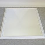 A white painted wall mirror,