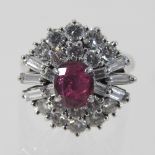 An 18 carat gold ruby and diamond cluster ring, approximately 20mm diameter, size L, 7.
