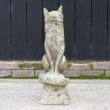 A reconstituted stone life size garden model of a fox,