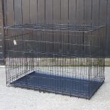 A folding metal dog cage,