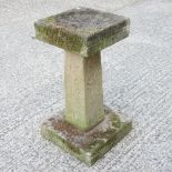 A reconstituted stone bird bath, with a square top,
