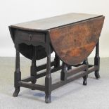 An 18th century oak gateleg table,