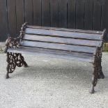 A modern black painted iron and wooden garden bench, of Victorian design,