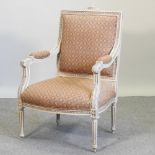 A French style carved cream painted and red upholstered open armchair