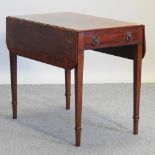 A 19th century mahogany and rosewood pembroke table, containing a single drawer,