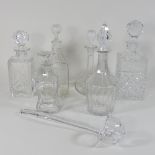 A collection of six glass decanters and stoppers,