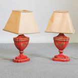 A pair of red painted urn shaped table lamps and shades,