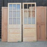 A collection of various pine doors, to include a pair of glazed doors,